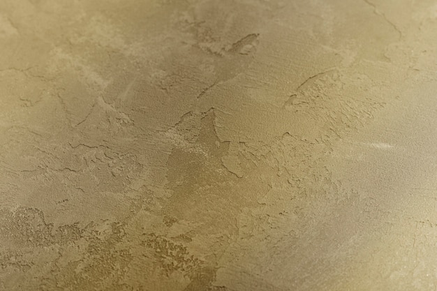 Decorative plaster in gold color. Background, texture