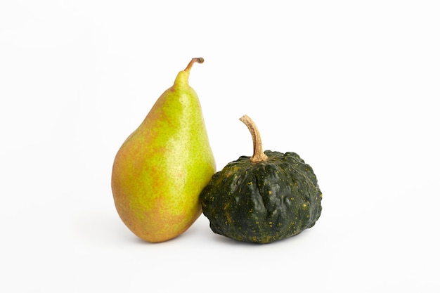 Decorative pumpkin and pear on white background