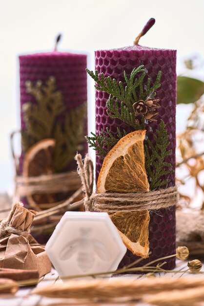 Decorative purple candles made of beeswax with a honey aroma for interior and tradition.