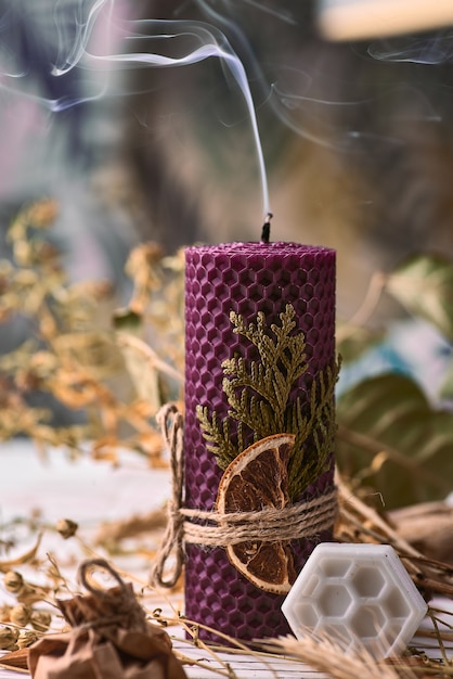 Decorative purple candles made of beeswax with a honey aroma for interior and tradition.