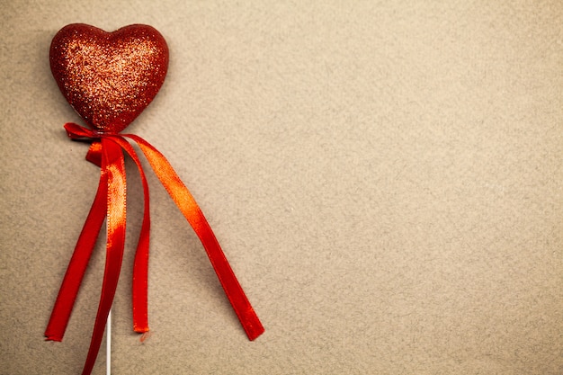 Decorative red heart on brown surface