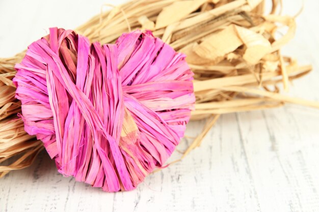 Decorative straw for hand made and heart of straw, on wooden background