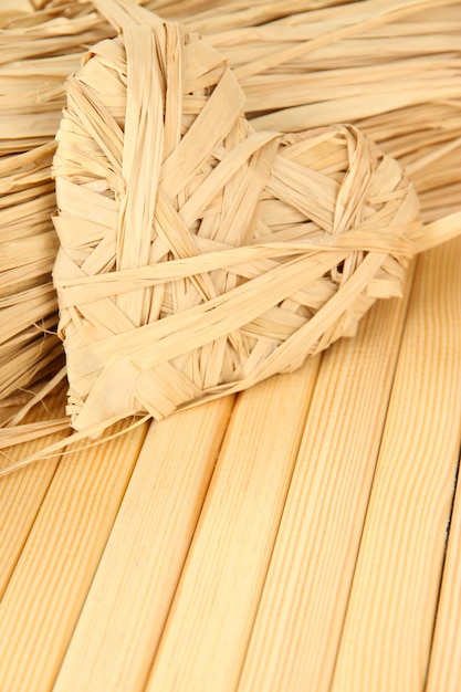 Decorative straw for hand made and heart of straw, on wooden background