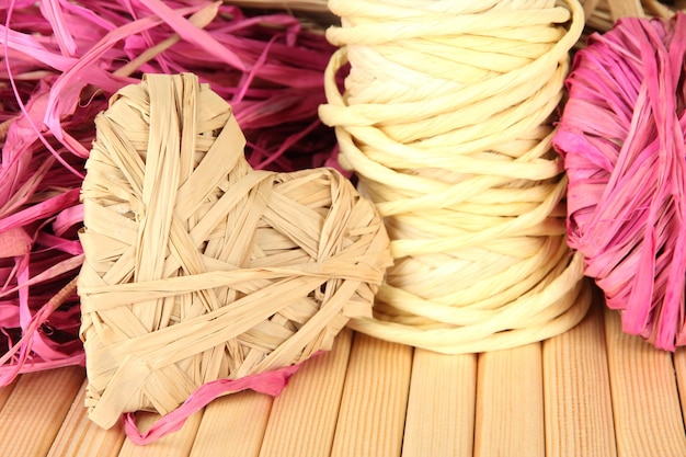 Decorative straw for hand made and heart of straw, on wooden background