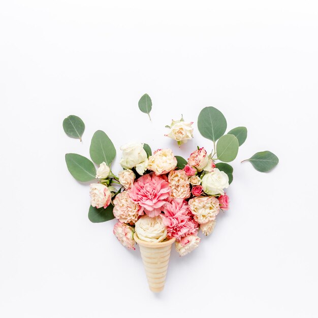 Decorative waffle cone is made of roses carnations and eucalyptus leaves flat lay top view valentine