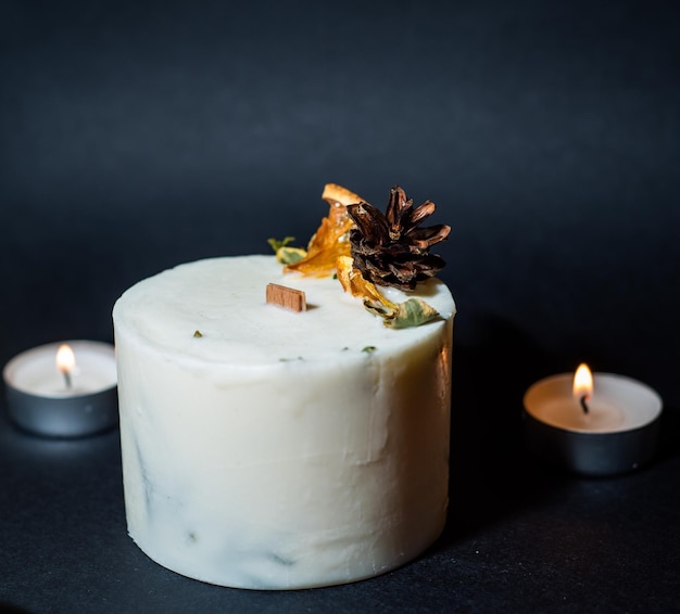 Decorative wax candle and decorates with dried flowers,
close-up