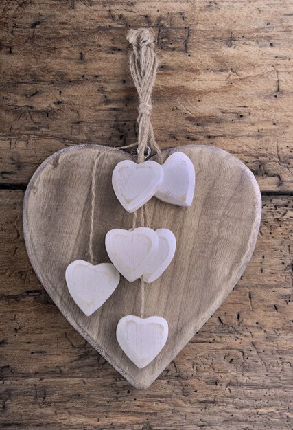 Decorative wooden hearts on plank