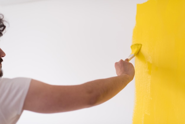 Decorator's hand painting wall with brush