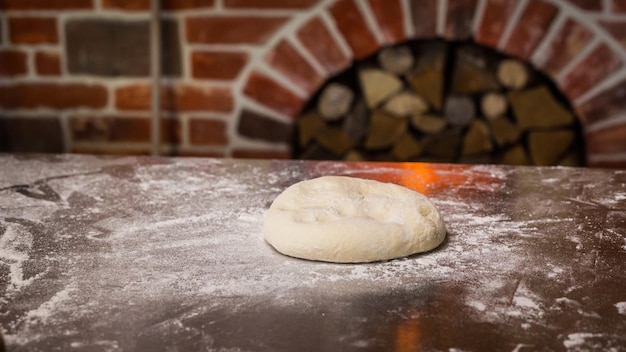 Foto deeg met bloem op tafel zelfgemaakt gebak voor brood of pizza bakkerijachtergrond