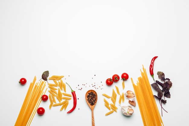 Deegwarenspaghetti met ingrediënten voor het koken van deegwaren op een witte achtergrond, hoogste mening.