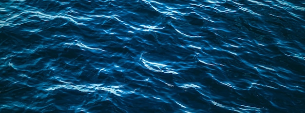 Deep blue ocean water texture dark sea waves background as nature and environmental design