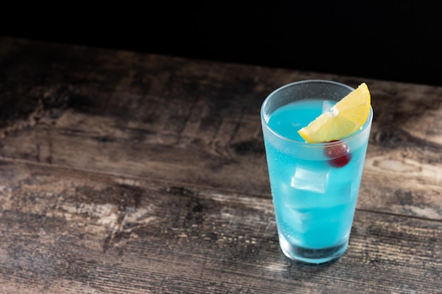 Deep blue sea martini cocktail on wooden table