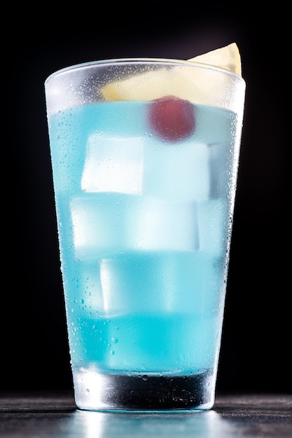 Deep blue sea martini cocktail on wooden tablexA