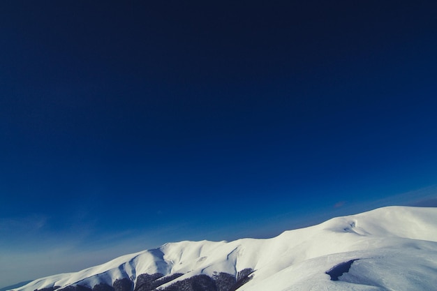 Deep blue sky above mountain peak landscape photo