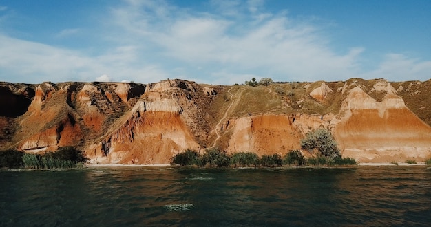 Deep clay canyon overgrown with green grass