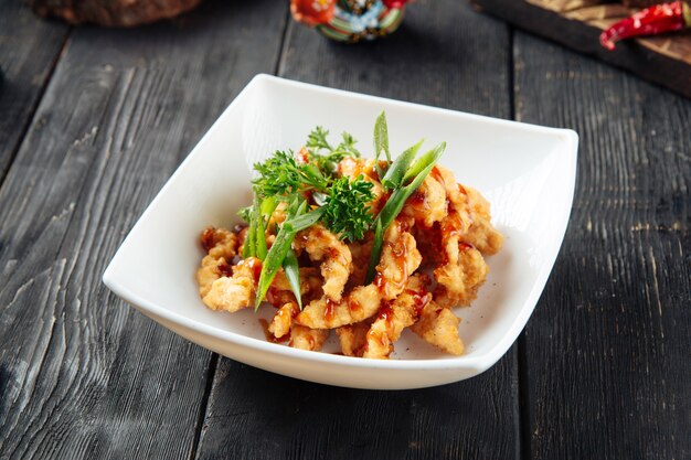 Deep fried asian chicken in a white plate