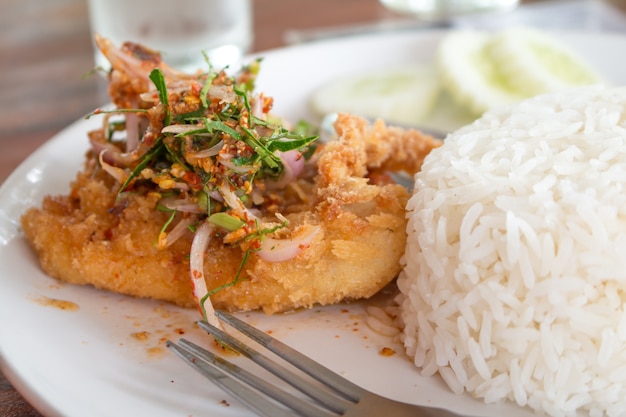 Deep Fried Dolly Fish Steak with sauce Stir basil crispy herb hot and spicy delicious Thai food style