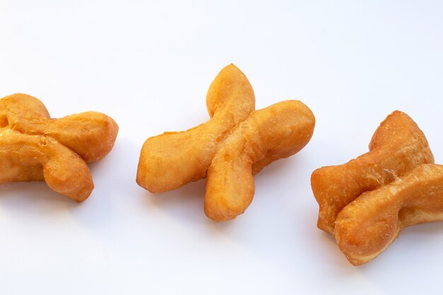 Deep-fried dough sticks or chinese bread sticks on white background.