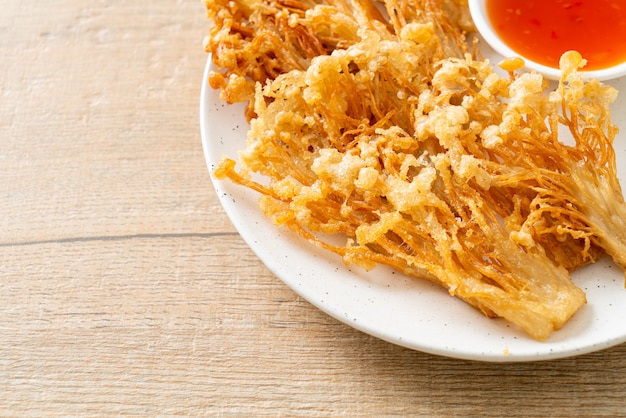 deep fried enoki mushroom or golden needle mushroom with spicy dipping sauce - vegan food style