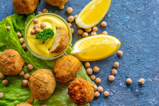 Deep-fried homemade vegetarian falafel made from ground chickpeas and broccoli, with mustard lemon sauce