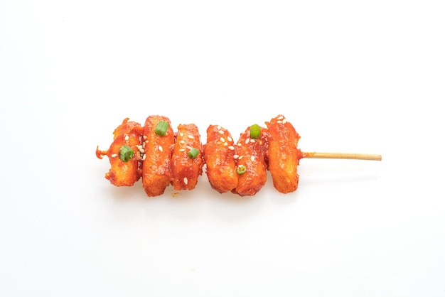 deep fried Korean rice cake (Tteokbokki) skewered with spicy sauce isolated on white background