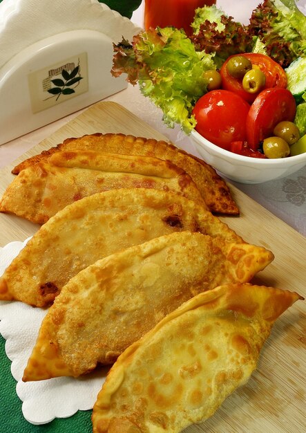 Deep fried meat pies and vegetable salad