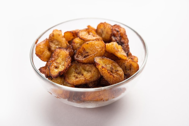 Deep fried ripe plantain slices or pake kele fried chips in a bowl