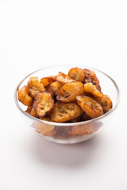 Deep fried ripe plantain slices or pake kele fried chips in a bowl