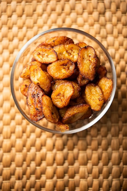 Deep fried ripe plantain slices or pake kele fried chips in a bowl