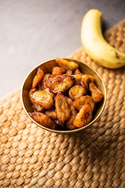 Deep fried ripe plantain slices or pake kele fried chips in a bowl