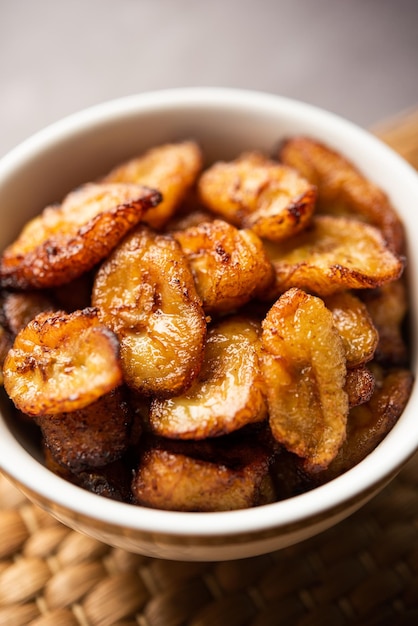 Deep fried ripe plantain slices or pake kele fried chips in a bowl