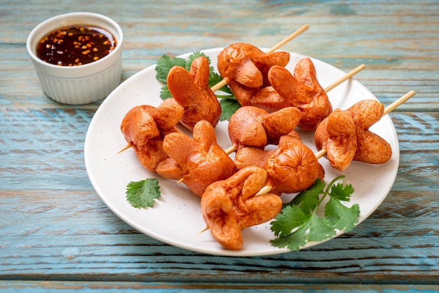 deep fried sausage skewer with dipping sauce