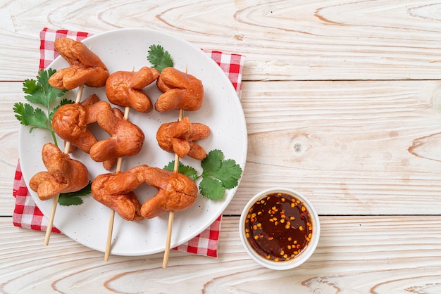 deep fried sausage skewer with dipping sauce