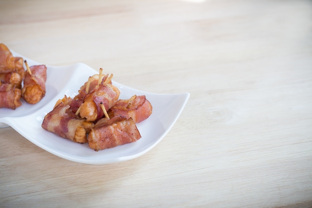 Deep fried sausages rolled in bacon