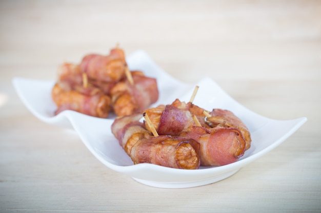 Deep fried sausages rolled in bacon