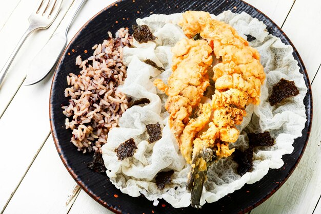 Deep fried sea bass fish with rice on rice paper Roasted seafood