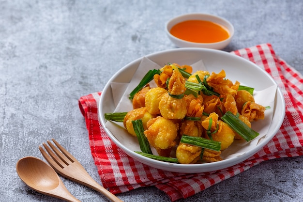 Deep fried wonton on the dark surface.