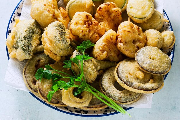 Deep frying vegetables in a plate on the table vegan option