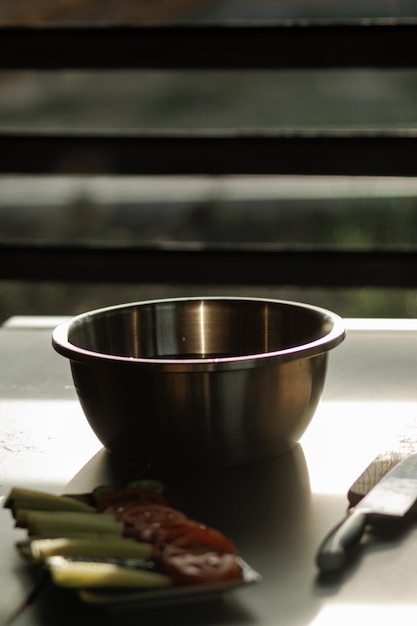 Photo deep metal salad bowl on table