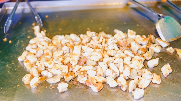 Deepfried squid eggs are being fried in a pan