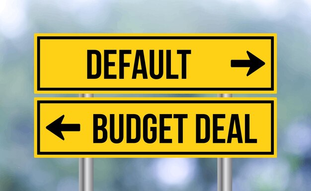 Default or budget deal road sign on blur background