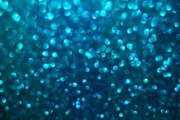 Defocused abstract background glittering with bright blue sparkles