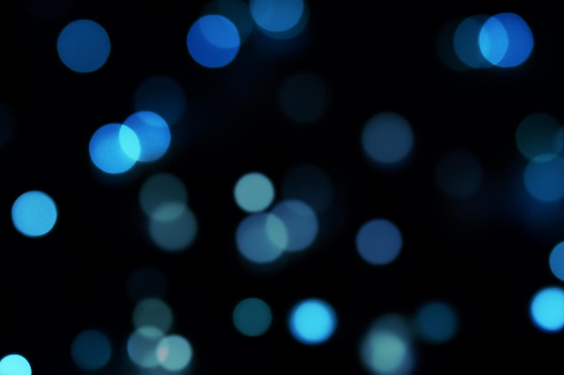 Defocused blue lights background over Dark