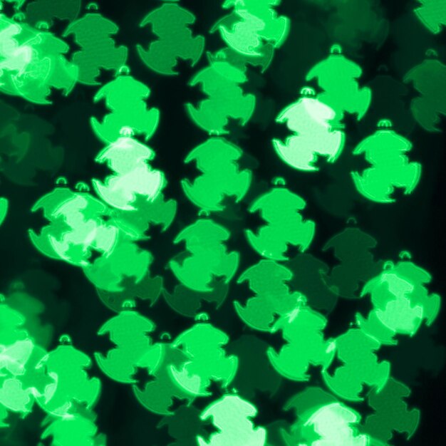 Defocused bokeh background with green christmas decoration balls