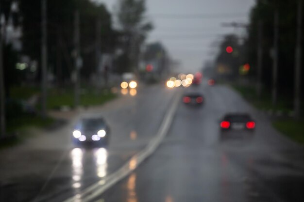 Defocused cars on road at summer heavy rain