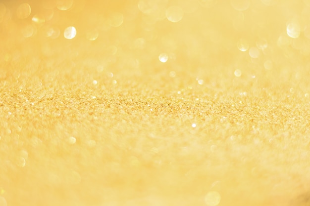 Defocused gold glitter background. Gold abstract bokeh background. 