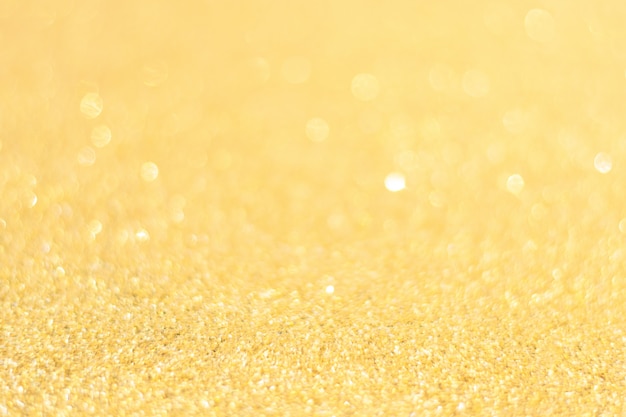 Defocused gold glitter background. Gold abstract bokeh background. 