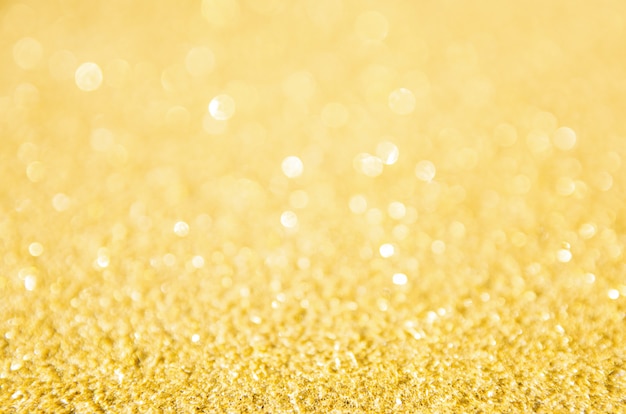 Defocused gold glitter background. Gold abstract bokeh background. 