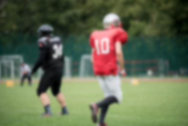 Photo defocused image of american football players playing on field