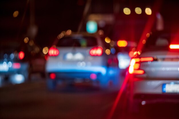 Photo defocused image of illuminated cars at night